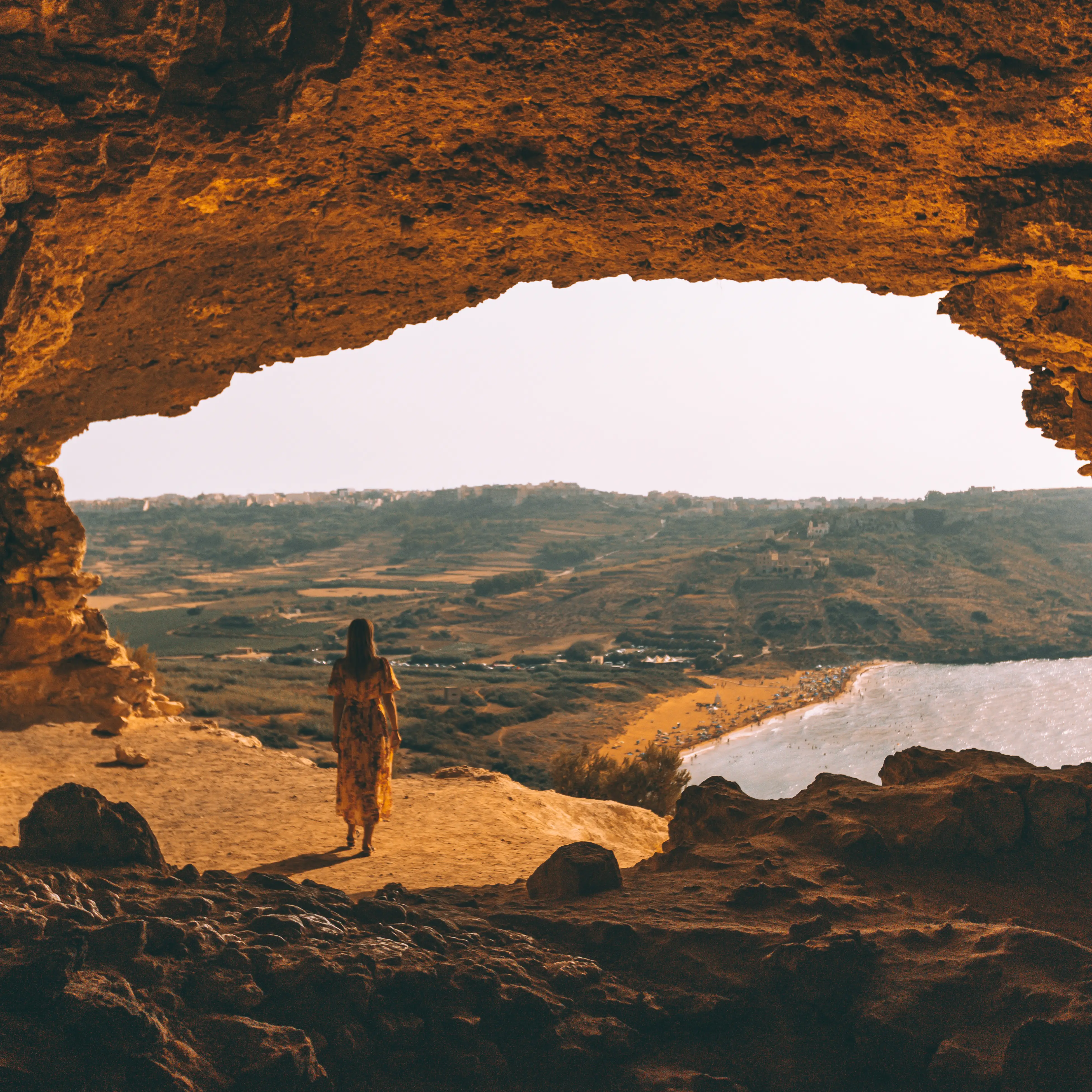 Tal -Mixta cave - Gozo Woman posing in tal Mixta cave, a famous spot for enjoying the view and sunset in Gozo. A popular Malta holiday Instagram spot.