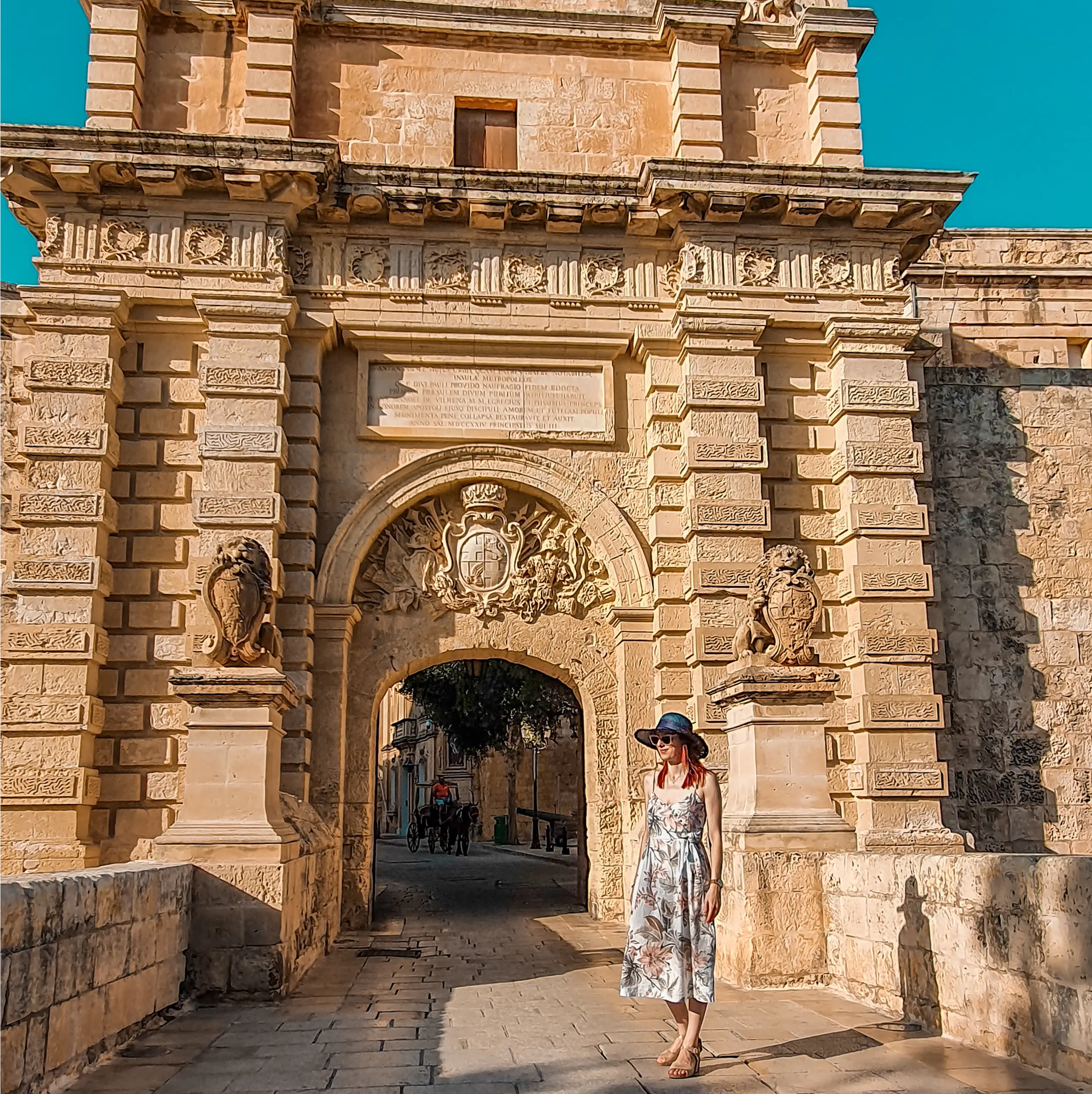 Mdina Gate An image of a woman standing in front of Mdina gate, the main entrance to Malta's past capital and witness to the Great Siege of 1565