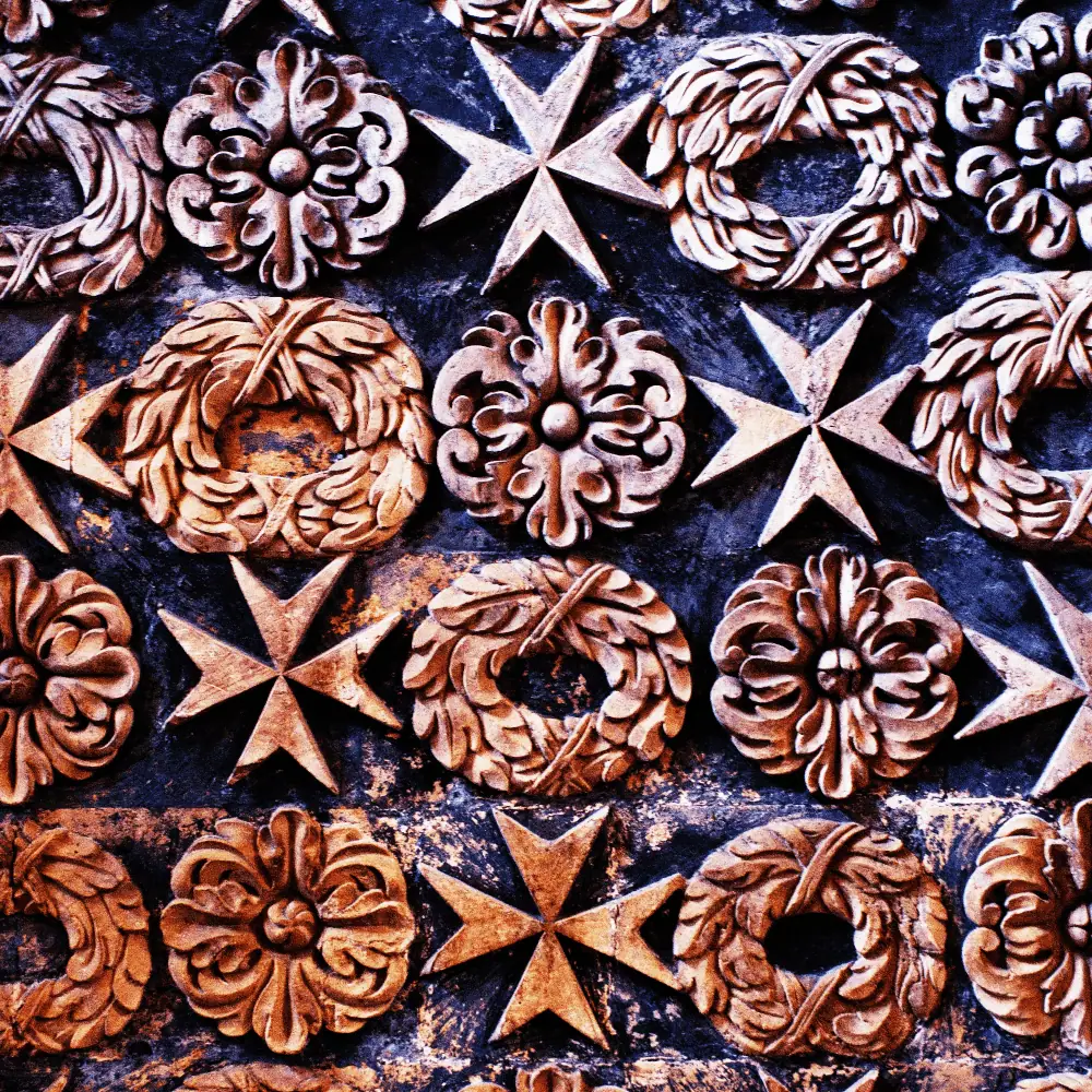 St. John's Co Cathedral Mural A carved mural inside St John's co cathedral, showcasing classic motifs including the famous Maltese cross. Visiting the inside of the Cathedral is one of the top things to do in Malta.
