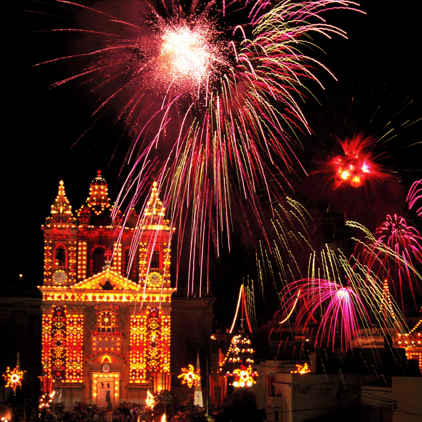 Maltese Church During Feast A shot of a Maltese church decorated for the feast, with fireworks in the foreground,.
