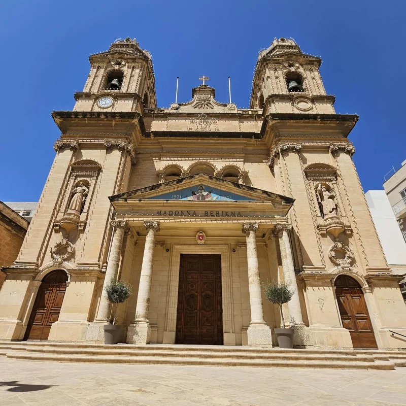 A close up shot of the Gzira parish church, adorned with festive lights in preparation for the village festa.