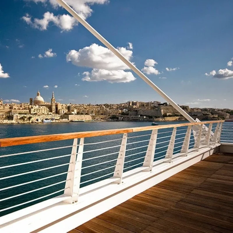 A shot of The Point's wooden viewpoint overlooking the harbor and with Valletta views.