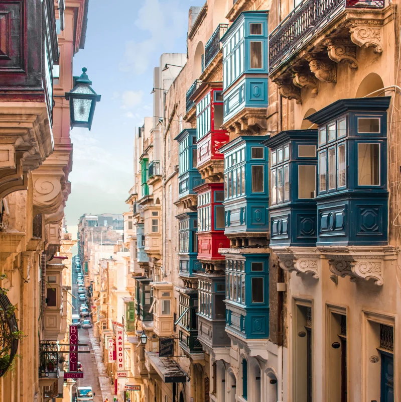 A side road in Valletta, including typical Maltese architecture as well as a colourful variety of Maltese balconies.